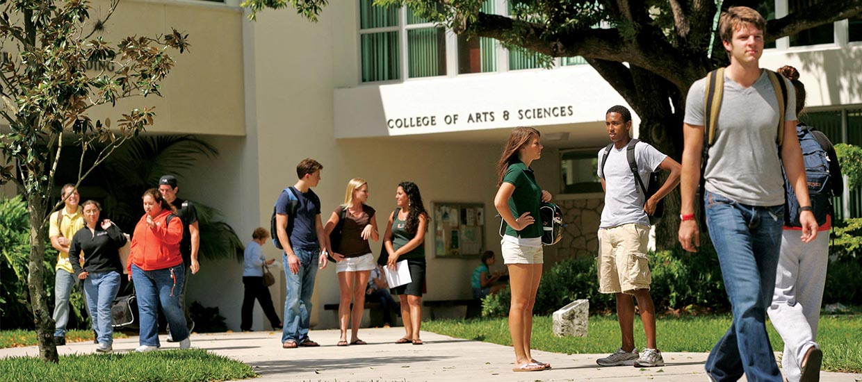 Students walking and socializing outside of the College of Arts and Sciences and Ashe buildings