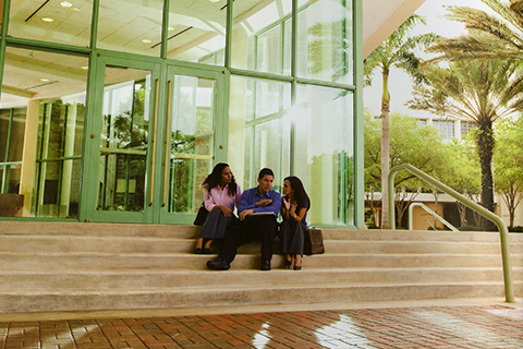 Students talking on the steps in front of Storer Auditorium