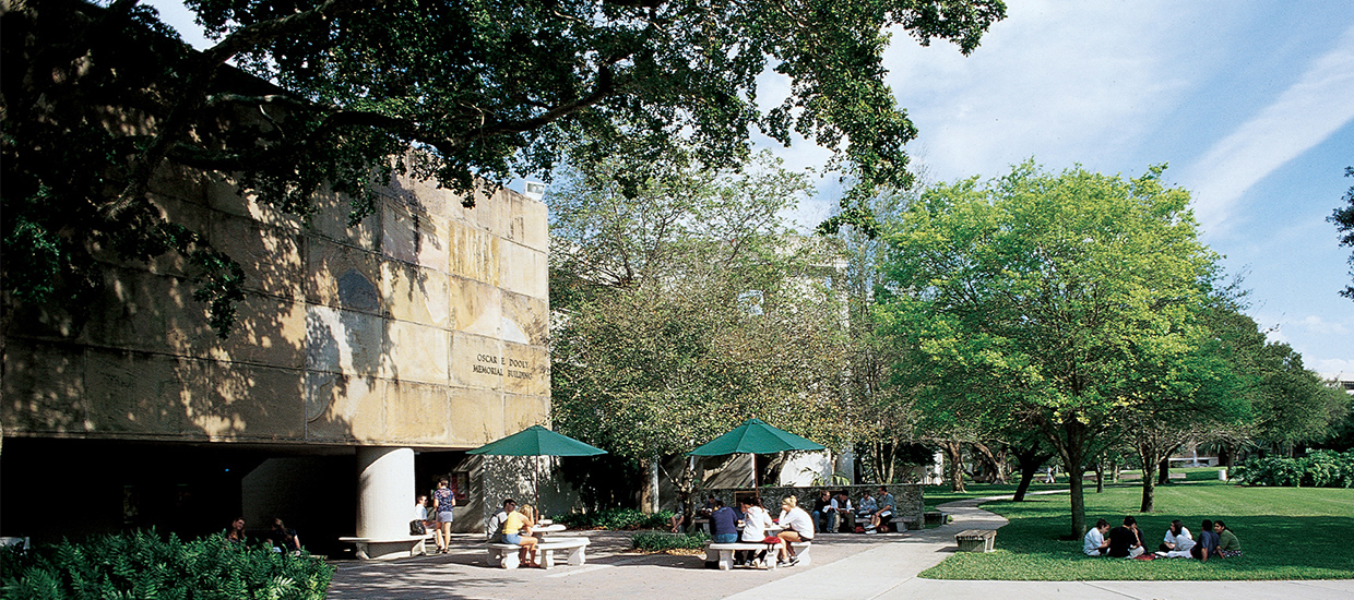 Students sitting in front of the Dooley Memorial building