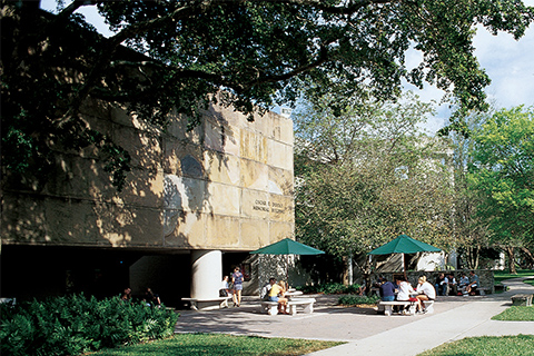 Students sitting in front of the Dooley Memorial building